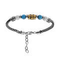 Bracelets sur Artemare : Bracelet en acier avec perles blanches et bleues avect tube finement d&eacute;cor&eacute; 19+3cm