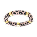 Bracelet extensible l&eacute;opard &agrave; anneaux dor&eacute;s fond blanc et tachet&eacute;s noir